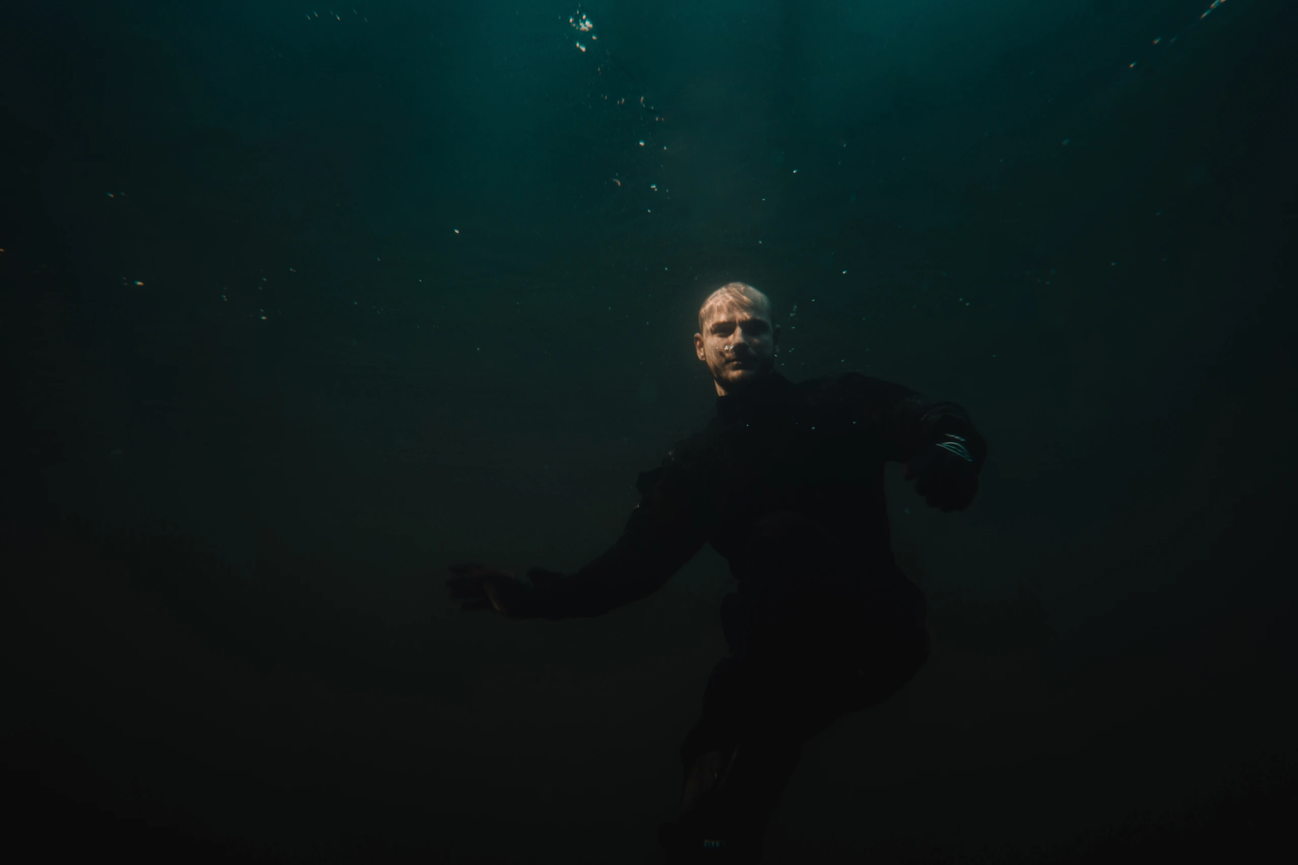 Sebastian underwater in a flight suit